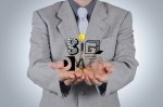 Business man in suit with focus on his hands, holding a graphical representation of words "big data"