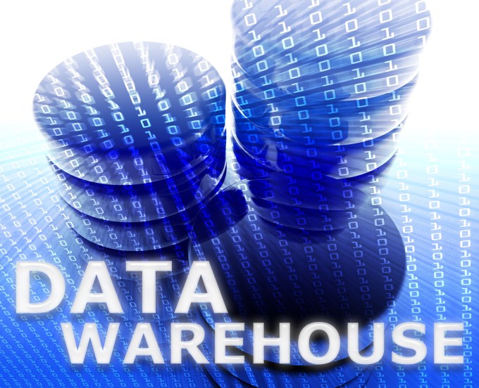 Data Warehouse concept picture. Two databases with zeros and ones flying out of them.