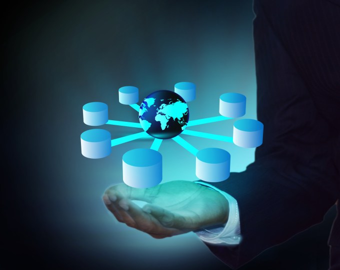 Drawing of man holding a database cluster in his hand with the earth at the center.
