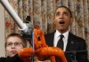 U.S. President Barack Obama reacts as Joey Hudy of Phoenix, Arizona launches a marshmallow from his Extreme Marshmallow Cannon in Washington