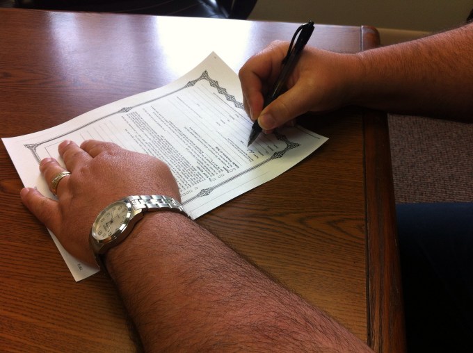 Man signing a contract.
