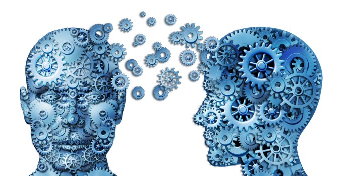 Two heads made out of gears exchanging information.