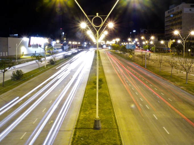 Picture of highway showing movement and streetlights.