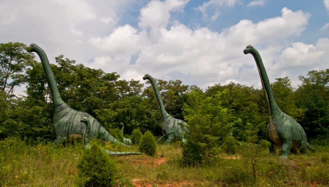 Dinosaurs roaming the land.