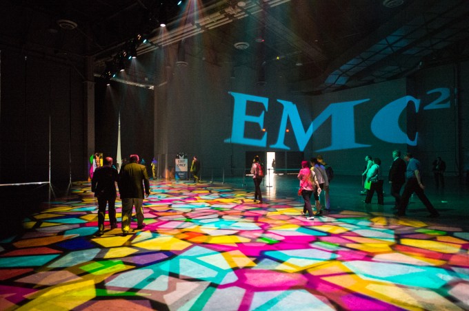 EMC logo over psychedelic dance floor