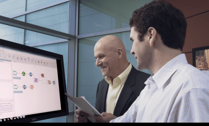 Two men working with Alteryx