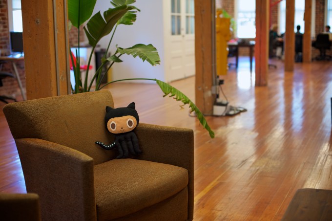 GitHub Offices with comfy chair with stuffed GitHub animal sitting on it.