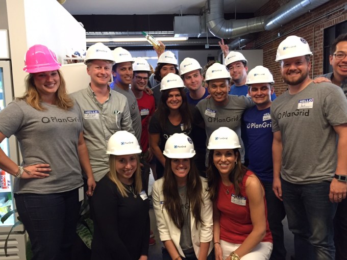 PlanGrid employees in PlanGrid construction hats and t-shirts.
