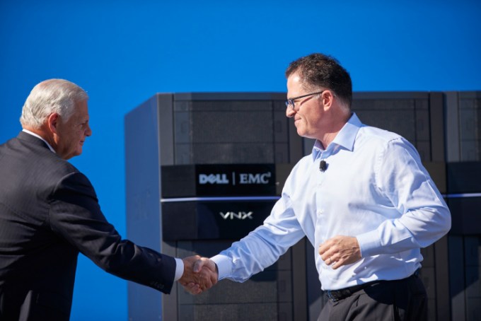 EMC CEO Joe Tucci shaking hands with Dell CEO Michael Dell.