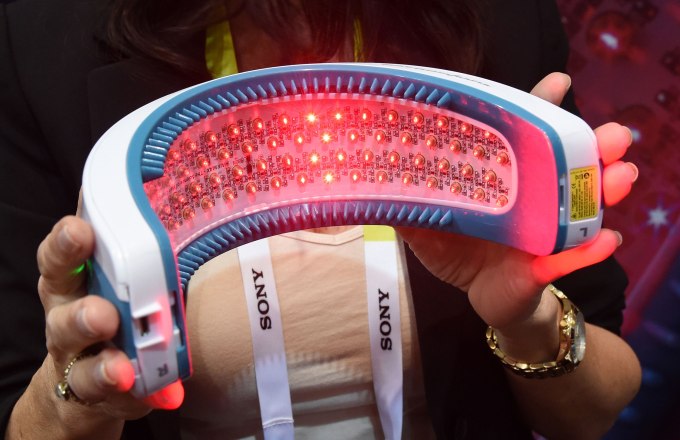 LAS VEGAS, NV - JANUARY 04: Francesca Dubsky display the bottom side of the Hairmax LaserBand 82 during a press event for CES 2016 at the Mandalay Bay Convention Center on January 4, 2016 in Las Vegas, Nevada. The USD 795 unit, designed by Pinin Farina, uses 90-second treatments of red laser light at 655 nanometers to grow hair by increasing blood flow to the scalp and stimulating hair follicles. CES, the world's largest annual consumer technology trade show, runs from January 6-9 and is expected to feature 3,600 exhibitors showing off their latest products and services to more than 150,000 attendees. (Photo by Ethan Miller/Getty Images)