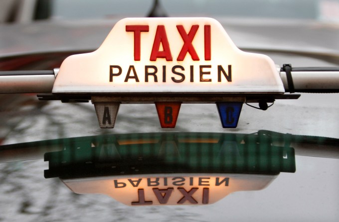The top of a taxi is seen in downtown Paris January 29, 2008. Taxi drivers will stage on Wednesday a protest in the centres of France's major cities. The National Taxi Owners Federation is fighting against a scheme to solve the country's chronic shortage of taxis by the abolition of tight quotas and the authorisation of minicabs.     REUTERS/Charles Platiau (FRANCE)