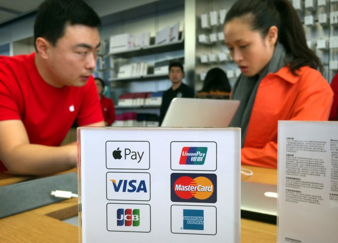 An employee works on a laptop computer as he talks with a customer near a sheet showing accepted methods of payment, including Apple Pay, top left, at an Apple Store in Beijing, Thursday, Feb. 18, 2016. Apple Inc. on Thursday launched its smartphone-based payment system in China where the...      </div>
  <div>
    </div>
    <div><a href=