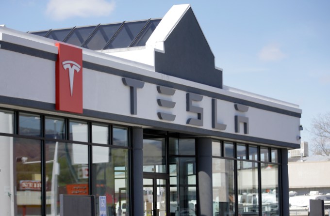 FILE - In this April 1, 2015, file photo shows the Tesla Motors new showroom in Salt Lake City. State lawmakers said Wednesday, May 20, 2015 they hope to work out a compromise law this year that would allow Tesla Motors to start selling its electric cars at its $3 million showroom in Salt Lake City. Two weeks before the showroom's planned opening in March, the Utah attorney general's office ruled that it couldn't sell cars under state laws barring a manufacturer from owning more than 45 percent of any dealership. (AP Photo/Rick Bowmer, File)