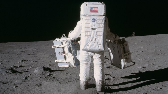 Astronaut and lunar module pilot Buzz Aldrin moves toward a position to deploy two components of the Early Apollo Scientific Experiments Package (EASEP) on the surface of the moon during the Apollo 11 extravehicular activity. The Passive Seismic Experiments Package (PSEP) is in his left hand; and in his right hand is the Laser Ranging Retro-Reflector (LR3). Mission commander Neil Armstrong took this photograph with a 70mm lunar surface camera.Image Credit: NASA