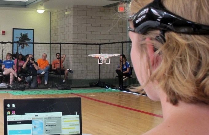 In this April 16, 2016 photo. a University of Florida student uses a brain-controlled interface headset to fly a drone during a mind-controlled drone race in Gainesville, Fla. For more than a century science has been able to detect brainwaves, but recent advances in cheaper equipment like the electroencephalogram, or EEG, headsets worn by the drone racers is moving the technology out of the lab.   (AP Photo/ Jason Dearen)