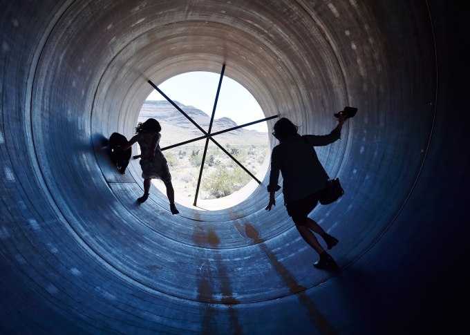 NORTH LAS VEGAS, NV - MAY 11:  People walk through a Hyperloop tube after the first test of a propulsion system at the Hyperloop One Test and Safety site on May 11, 2016 in North Las Vegas, Nevada. The company plans to create a fully operational hyperloop system by 2020.  (Photo by David Becker/Getty Images)