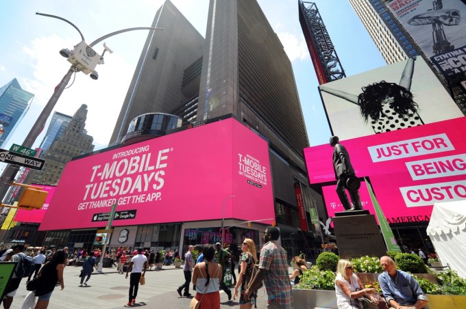 T-Mobile announces Un-carrier 11, called T-Mobile Tuesdays, during a live simulcast from the T-Mobile Times Square store in New York, Monday, June 6, 2016. The latest Un-carrier move gives customers free gifts every week and shares of company stock. (Diane Bondareff/AP Images for T-Mobile)