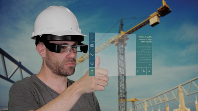 Man using smart glasses at a construction site.