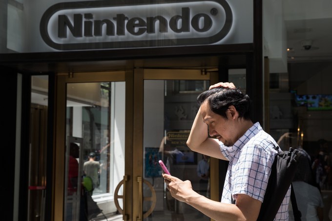 NEW YORK, NY - JULY 11: A man plays Pokemon Go on his smartphone outside of Nintendo's flagship store, July 11, 2016 in New York City.  The success of Nintendo's new smartphone game, Pokemon Go, has sent shares of Nintendo soaring. (Photo by Drew Angerer/Getty Images)