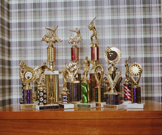 Various sports trophies on table