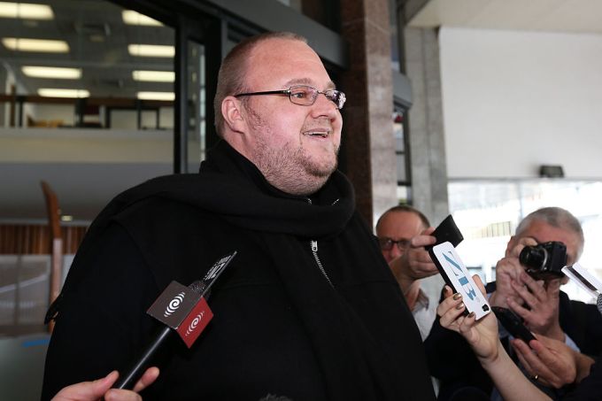 AUCKLAND, NEW ZEALAND - DECEMBER 01: Kim Dotcom speaks to the media following hs bail hearing at Auckland District Court on December 1, 2014 in Auckland, New Zealand. Dotcom has avoided going back to jail after Judge Nevin Dawson imposed tighter bail conditions including reporting to police twice a week for is forbidden from private air or sea travel. Dotcom was raided in 2012 after the U.S. claimed his MegaUpload service had cost copyright owners $500 million by facilitating internet piracy. (Photo by Fiona Goodall/Getty Images)