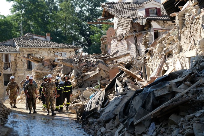 Italian firefighters and soldier walk amid ruins during operation aiming at reopening the road in Rio, a little village near Amatrice, central Italy two days after a 6.2-magnitude earthquake struck the region killing some 267 people and injuring at least 367 people.   An increasingly forlorn search for victims of the earthquake that brought carnage to central Italy entered a third day on August 26 but no one has been pulled alive from the piles of collapsed masonry since August 24 evening. / AFP / MARIO LAPORTA        (Photo credit should read MARIO LAPORTA/AFP/Getty Images)