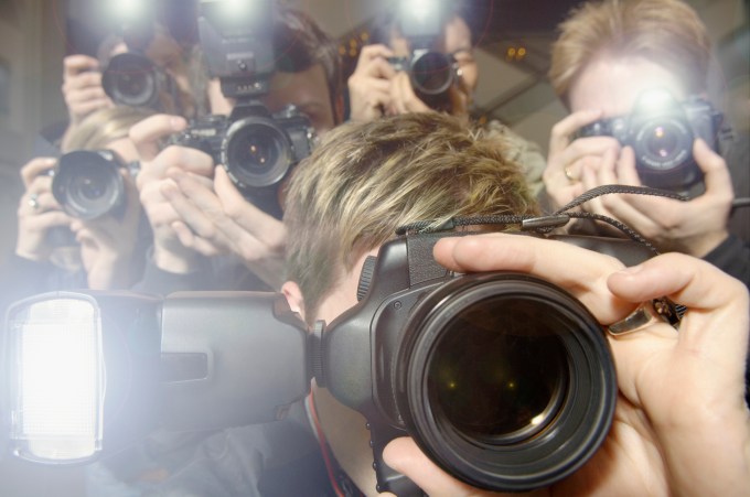 Paparazzi taking photographs of celebrity --- Image by © Monalyn Gracia/Corbis
