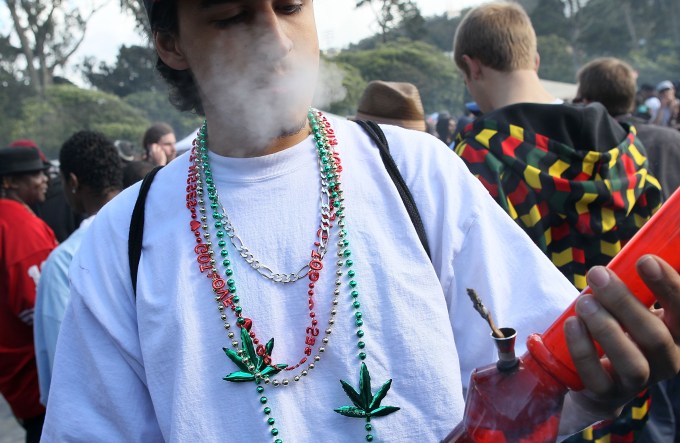SAN FRANCISCO - APRIL 20:  A marijuana user smokes from a bong during a 420 Day celebration on "Hippie Hill" in Golden Gate Park April 20, 2010 in San Francisco, California. April 20th has become a de facto holiday for marijuana advocates, with large gatherings and 'smoke outs' in many parts of the United States. Voters in California will consider a measure on the November general election ballot that could make the State the first in the nation to legalize the growing of a limited amount of marijuana for private use.  (Photo by Justin Sullivan/Getty Images)