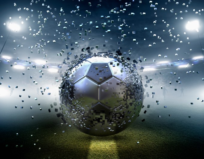 Futuristic silver soccer ball exploding into pixels