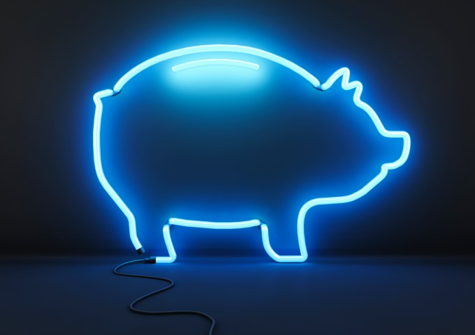 Neon blue piggy bank on black background