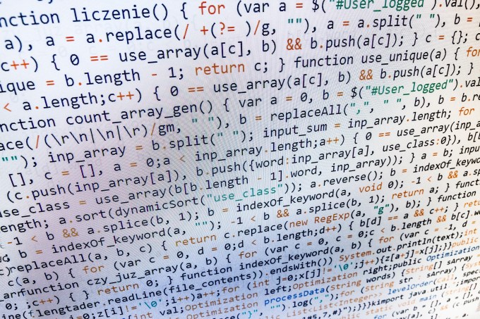 Software developer programming code on computer. Abstract computer script source code.