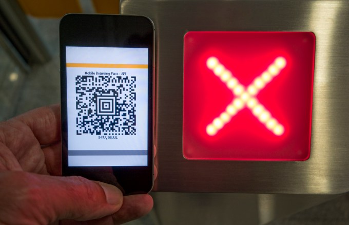 Mobile Boarding pass on a smart phone and ticket scanner at the airport. Photo: Thomas Winz/Lonely Planet Images