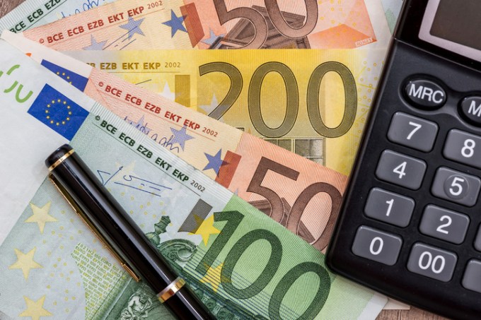euro, calculator and pen on desk