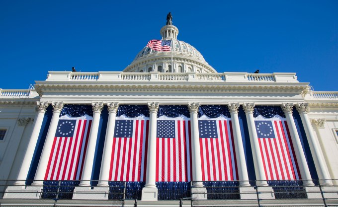American flags hang at the United States Capitol, in preparation for President Obama's second term inauguration ceremony in Washington, DC. (Photo by Brooks Kraft LLC/Corbis via Getty Images)