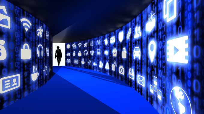 A silhouette of a hacker with a black hat in a suit enters a hallway with walls textured with blue internet of things icons 3D illustration cybersecurity concept