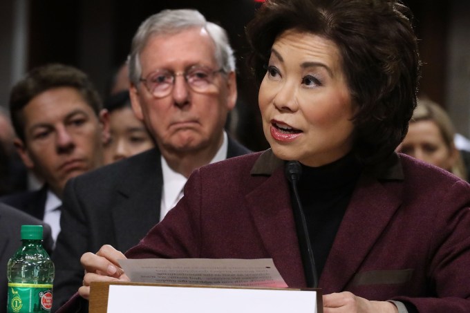 WASHINGTON, DC - JANUARY 11:  Elaine Chao testifies during her confirmation hearing to be the next U.S. secretary of transportation before the Senate Commerce, Science and Transportation Committee as her husband, Senate Majority Leader Mitch McConnell (R-KY) (2nd L) looks on, in the Dirksen Senate Office Building on Capitol Hill January 11, 2017 in Washington, DC. Chao, who has previously served as secretary of the Labor Department, was nominated by President-elect Donald Trump.  (Photo by Chip Somodevilla/Getty Images)