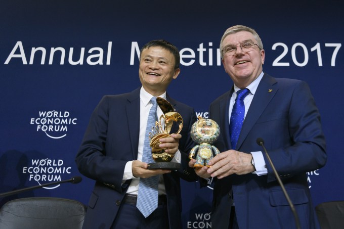 Alibaba Group Founder and Executive Chairman, China's Jack Ma (L) poses next to International Olympic Comittee (IOC) president Thomas Bach as they exchange gifts during the anouncement of a long-term partnership of Alibaba as worldwide sponsor on the sideline of the Forum's annual meeting, on January 19, 2017 in Davos. / AFP / FABRICE COFFRINI        (Photo credit should read FABRICE COFFRINI/AFP/Getty Images)