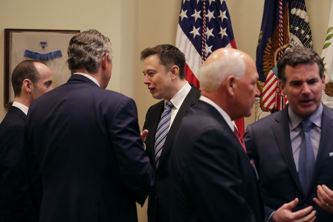 WASHINGTON, DC - JANUARY 23:  White House Senior Advisor Stephen Miller (L) and Klaus Kleinfeld of Arconic visit with Elon Musk (C) of SpaceX before a meeting with U.S. President Donald Trump in the Roosevelt Room at the White House January 23, 2017 in Washington, DC. Business leaders who also attend the meeting included Elon Musk of SpaceX, Mark Sutton of International Paper, Michael Dell of Dell Technologies, Marillyn Hewson of Lockheed Martin, Andrew Liveris of Dow Chemical and others.  (Photo by Chip Somodevilla/Getty Images)