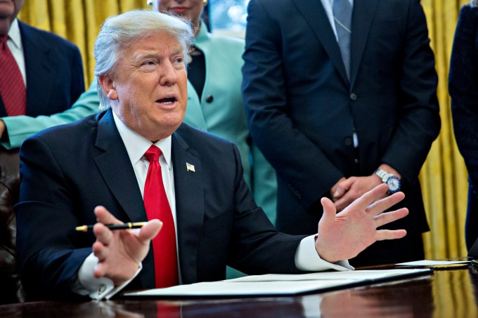 U.S. President Donald Trump speaks before signing an executive order surrounded by small business leaders in the Oval Office of the White House January 30, 2017 in Washington, DC. Trump said he will "dramatically" reduce regulations overall with this executive action as it requires that for every new federal regulation implemented, two must be rescinded. (Photo by Andrew Harrer - Pool/Getty Images)