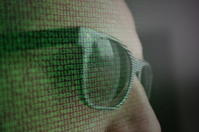 Double Exposure Of Computer Language And Man Wearing Sunglasses