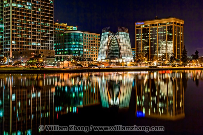 Cathedral of Christ the Light and nearby buildings reflect in Lake Merritt in Oakland.