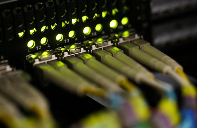 Fibre-optic cables feed into a server inside a comms room at an office in London, U.K., on Friday, Oct. 16, 2015. A group of Russian hackers infiltrated the servers of Dow Jones & Co., owner of the Wall Street Journal and several other news publications, and stole information to trade on before it became public, according to four people familiar with the matter. Photographer: Chris Ratcliffe/Bloomberg via Getty Images
