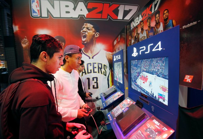PARIS, FRANCE - OCTOBER 28:  Gamers play the video game "NBA 2K 17" developed by Visual Concepts and published 2K Sports on Sony PlayStation game consoles PS4 during the "Paris Games Week" on October 28, 2016 in Paris, France. "Paris Games Week" is an international trade fair for video games to be held from October 27 to October 31, 2016.  (Photo by Chesnot/Getty Images)