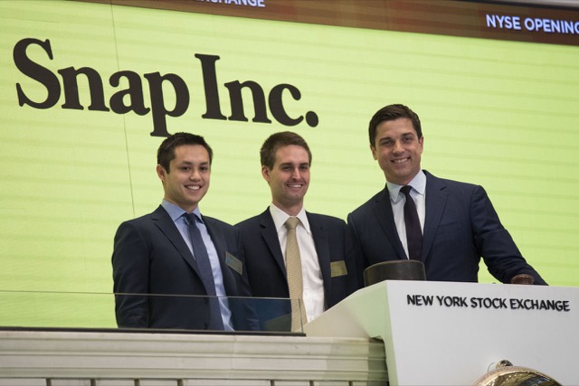 NEW YORK, NY - MARCH 2: (L to ) Snapchat co-founders Bobby Murphy, chief technology officer of Snap Inc., and Evan Spiegel, chief executive officer of Snap Inc., prepare to ring the opening bell as Thomas Farley, president of the NYSE, looks on, March 2, 2017 in New York City. Snap Inc. priced its initial public offering at $17 a share on Wednesday and Snap shares will start trading on the New York Stock Exchange (NYSE) on Thursday. (Photo by Drew Angerer/Getty Images)