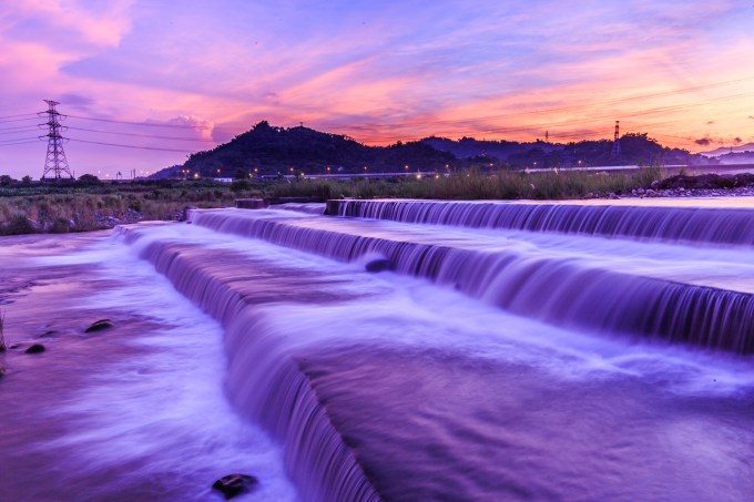 Majestic River Flowing At Sunset